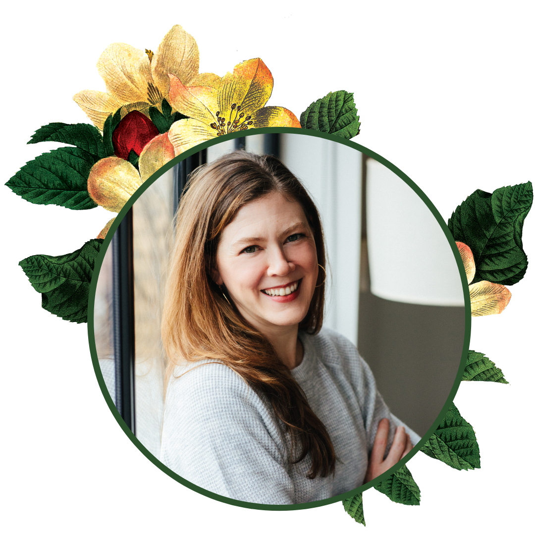 photo of Elizabeth Passarella with arms folded, smiling, framed by magnolias